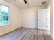 Bedroom featuring wood-look floors, neutral walls, a ceiling fan, and a bright window at 24009 Sw Huckleberry Ln, Dunnellon, FL 34431