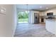 Bright kitchen featuring stainless steel appliances, white cabinets and sliding door access to backyard at 24009 Sw Huckleberry Ln, Dunnellon, FL 34431