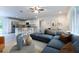 Living room and kitchen area featuring a breakfast bar with granite countertops, new appliances, and modern sofa at 24009 Sw Huckleberry Ln, Dunnellon, FL 34431