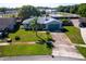 Overhead view of home with large front lawn, driveway, and landscaping in a suburban neighborhood setting at 8400 Mattituck Cir, Orlando, FL 32829