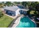 Backyard aerial view featuring a pool, fence, patio, and lush greenery surrounding the property at 8400 Mattituck Cir, Orlando, FL 32829