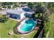 Aerial view of home featuring a screened pool area, green lawn and proximity to neighboring houses at 8400 Mattituck Cir, Orlando, FL 32829