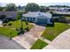 Aerial view of a home with a manicured front yard, long driveway, and neighborhood surroundings at 8400 Mattituck Cir, Orlando, FL 32829