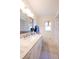 Bathroom featuring a white vanity with a light marble countertop, a decorative mirror and tiled floors at 8400 Mattituck Cir, Orlando, FL 32829