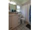 Bathroom with a white vanity and a decorative mirror with a window for lots of natural light at 8400 Mattituck Cir, Orlando, FL 32829