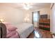 Cozy bedroom featuring a ceiling fan, wood laminate floors, and a contemporary dresser with a television at 8400 Mattituck Cir, Orlando, FL 32829