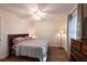 Cozy bedroom featuring hardwood floors, ceiling fan, and bright natural light at 8400 Mattituck Cir, Orlando, FL 32829