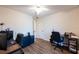 Neutral-toned bedroom with hardwood floors, ceiling fan, and filled with natural light at 8400 Mattituck Cir, Orlando, FL 32829