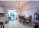 Light-filled dining area with sliding glass doors that lead to a screened in lanai at 8400 Mattituck Cir, Orlando, FL 32829