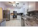 This kitchen features stainless steel appliances, granite countertops, and white cabinets at 8400 Mattituck Cir, Orlando, FL 32829