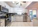 This kitchen features stainless steel appliances, granite countertops, and white cabinets at 8400 Mattituck Cir, Orlando, FL 32829