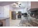 This kitchen features stainless steel appliances, granite countertops, and white cabinets at 8400 Mattituck Cir, Orlando, FL 32829