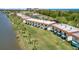 An aerial view of a waterfront condo complex with manicured lawns and mature palm trees at 26 Ocean Palm Villa S # 26, Flagler Beach, FL 32136
