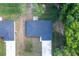 Drone shot highlighting the roof and proximity to neighbor, the driveway, and natural surroundings at 18 Malauka Loop Pass, Ocklawaha, FL 32179