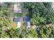 Aerial view displays the home nestled between verdant trees, showcasing the property lines with adjacent homes at 18 Malauka Loop Pass, Ocklawaha, FL 32179