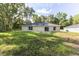 This backyard offers a simple patio space and a lush lawn extending from the home at 18 Malauka Loop Pass, Ocklawaha, FL 32179