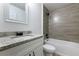A bathroom featuring a combination tub and shower, paired with a single sink vanity at 18 Malauka Loop Pass, Ocklawaha, FL 32179