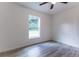 This bedroom offers natural light, neutral paint, and wood-look floors for a modern look at 18 Malauka Loop Pass, Ocklawaha, FL 32179
