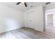This bedroom features neutral paint, wood-look floors, and a closet for practical storage at 18 Malauka Loop Pass, Ocklawaha, FL 32179