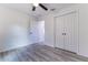 This bedroom features neutral paint, wood-look floors, and a closet for practical storage at 18 Malauka Loop Pass, Ocklawaha, FL 32179