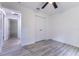This bedroom features neutral paint, wood-look floors, and a closet for practical storage at 18 Malauka Loop Pass, Ocklawaha, FL 32179