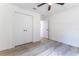 This bedroom features neutral paint, wood-look floors, and a closet for practical storage at 18 Malauka Loop Pass, Ocklawaha, FL 32179