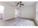 A clean and bright bedroom with wood-look floors, ceiling fan, and neutral walls and trim at 18 Malauka Loop Pass, Ocklawaha, FL 32179