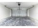 A spacious garage with sealed concrete floors provides ample storage and functionality at 18 Malauka Loop Pass, Ocklawaha, FL 32179