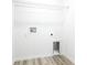 A white, well-lit laundry room with wood-look floor ready for washer and dryer at 18 Malauka Loop Pass, Ocklawaha, FL 32179