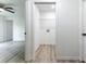 Hallway leading to a laundry room with wood-look floors ready for washer and dryer at 18 Malauka Loop Pass, Ocklawaha, FL 32179