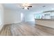 Open-concept living space with stylish wood-look flooring, combining comfort and contemporary design at 18 Malauka Loop Pass, Ocklawaha, FL 32179