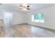 The large living area, featuring wood-look flooring and natural light, is adjacent to the kitchen at 18 Malauka Loop Pass, Ocklawaha, FL 32179