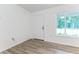 Bright room with laminate floors, features a window letting in natural light, and a crisp, clean door at 18 Malauka Loop Pass, Ocklawaha, FL 32179