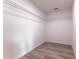 A walk-in closet with white walls, wood-look flooring, and metal shelving at 18 Malauka Loop Pass, Ocklawaha, FL 32179