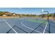 Outdoor basketball and tennis courts for community recreation, surrounded by mature trees and greenery at 4410 Sw 52Nd Cir # 108, Ocala, FL 34474