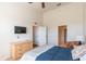 Spacious bedroom with a tv, dresser, neutral colors and adjacent en-suite bathroom at 4410 Sw 52Nd Cir # 108, Ocala, FL 34474