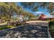 Welcoming entrance to Prairie Club featuring manicured landscaping, stone signage, and brick paved road at 4410 Sw 52Nd Cir # 108, Ocala, FL 34474