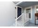 Image of the front door painted navy blue with white trim and a small porch at 4410 Sw 52Nd Cir # 108, Ocala, FL 34474