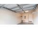 Clean two-car garage showcasing the garage door mechanism, painted walls, and practical shelving at 4410 Sw 52Nd Cir # 108, Ocala, FL 34474
