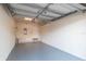 Spacious two-car garage with painted walls and floor, overhead lighting, and ample storage shelving at 4410 Sw 52Nd Cir # 108, Ocala, FL 34474