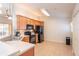 Bright kitchen featuring black appliances, light cabinets, and tiled floor, offering ample counter space at 4410 Sw 52Nd Cir # 108, Ocala, FL 34474