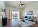 Comfortable living room with vaulted ceilings, area rug, modern decor and sliding glass doors at 4410 Sw 52Nd Cir # 108, Ocala, FL 34474