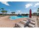 Stunning community pool with lounge chairs, sun umbrellas, and lush landscaping in a relaxing setting at 4410 Sw 52Nd Cir # 108, Ocala, FL 34474
