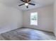 Bedroom features light wood flooring, ceiling fan, and window with natural light at 61 Fisher Way Crse, Ocklawaha, FL 32179