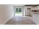 Dining room with vinyl floors, sliding glass doors and access to modern kitchen at 61 Fisher Way Crse, Ocklawaha, FL 32179
