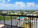 Scenic aerial view of the community showcasing the pool, tennis courts, surrounding homes, and distant ocean views at 3370 Ocean Shore Blvd # 5020, Ormond Beach, FL 32176