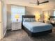 Cozy bedroom features a queen-sized bed, mirrored closet doors, and a large window for natural light at 3370 Ocean Shore Blvd # 5020, Ormond Beach, FL 32176