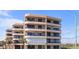Coastal multi-story condo building showcasing a light stucco exterior, balconies, and ocean views at 3370 Ocean Shore Blvd # 5020, Ormond Beach, FL 32176