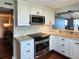 Well-lit kitchen featuring granite countertops, stainless appliances, and white cabinetry with backsplash at 3370 Ocean Shore Blvd # 5020, Ormond Beach, FL 32176