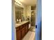 Elegant bathroom with dual vanities, granite countertops, and a spacious walk-in shower at 5108 Caspian St, St Cloud, FL 34771